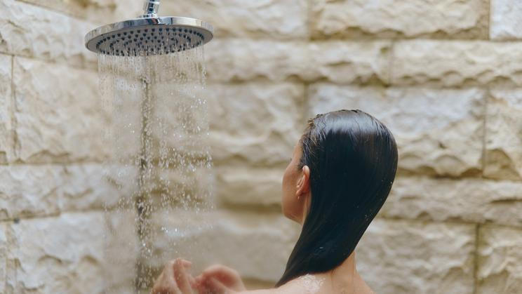 Woman,Showering,With,Wet,Hair,Under,Rainfall,Showerhead,In,Outdoor