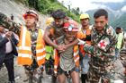 A man who survived is carried by members of a search and rescue team after being rescued from inside a tunnel at the Trishuli-3A Hydropower Project following devastating floods and mudslides that struck the Bhotekoshi River