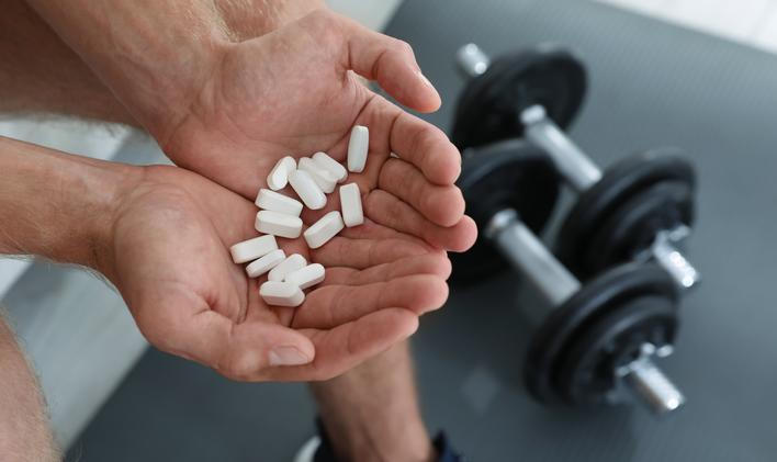 Man,With,Handful,Of,Pills,Indoors,,Closeup.,Doping,Concept