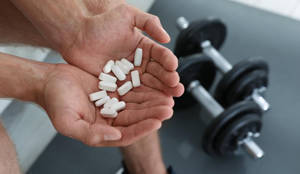 Man,With,Handful,Of,Pills,Indoors,,Closeup.,Doping,Concept