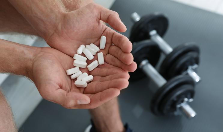 Man,With,Handful,Of,Pills,Indoors,,Closeup.,Doping,Concept