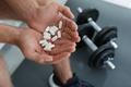 Man,With,Handful,Of,Pills,Indoors,,Closeup.,Doping,Concept
