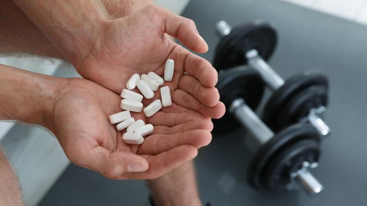 Man,With,Handful,Of,Pills,Indoors,,Closeup.,Doping,Concept