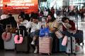 Stranded passengers wait at terminal as Soekarno Hatta International Airport closed its operations due to the eruption of the Mount Anak Krakatau volcano, in Tangerang