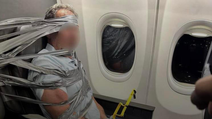Cestující z letu American Airlines připoutaný lepicí páskou k sedačce. Snímek z Instagramu Maximm Magazine.
