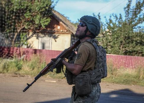 Ukrainian serviceman observes the sky for Russian drones in the frontline town of Druzhkivka