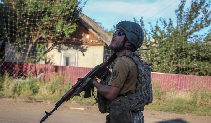 Ukrainian serviceman observes the sky for Russian drones in the frontline town of Druzhkivka