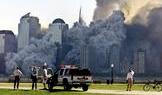 The remaining tower of New York's World Trade Center, Tower 2, dissolves in a cloud of dust and debr..