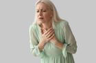 Mature,Woman,Having,Heart,Attack,On,Grey,Background