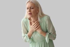 Mature,Woman,Having,Heart,Attack,On,Grey,Background