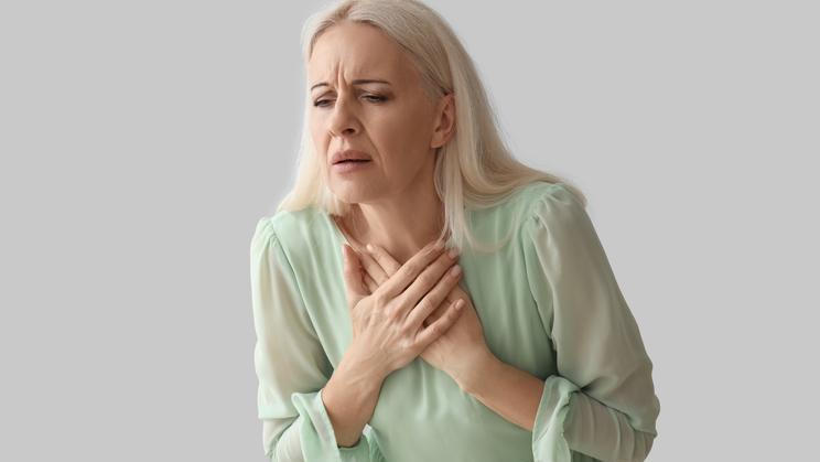 Mature,Woman,Having,Heart,Attack,On,Grey,Background
