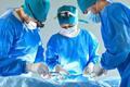 Team,Of,Professional,Doctors,Surgeons,Wearing,Blue,Medical,Uniform,Performing