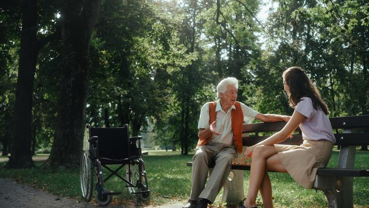 Young,Caregiver,Playing,Chess,With,Lonely,Senior,Client,In,The