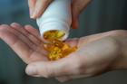 Close-up,Of,A,Woman,Pouring,Vitamin,D,Or,Omega-3,Into