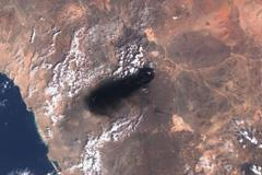 A satellite image shows black smoke rising from an area of Saudi Arabia’s East-West oil pipeline south of Medina
