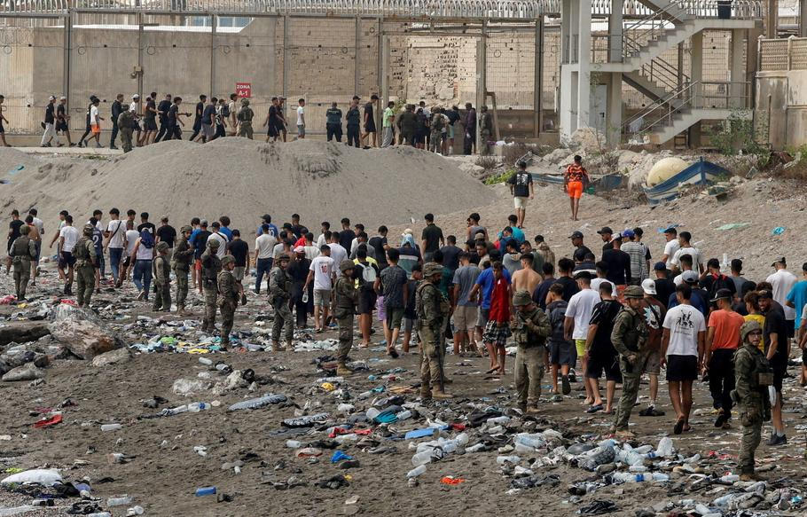 FILE PHOTO: Migrants cross into the Spanish enclave of Ceuta