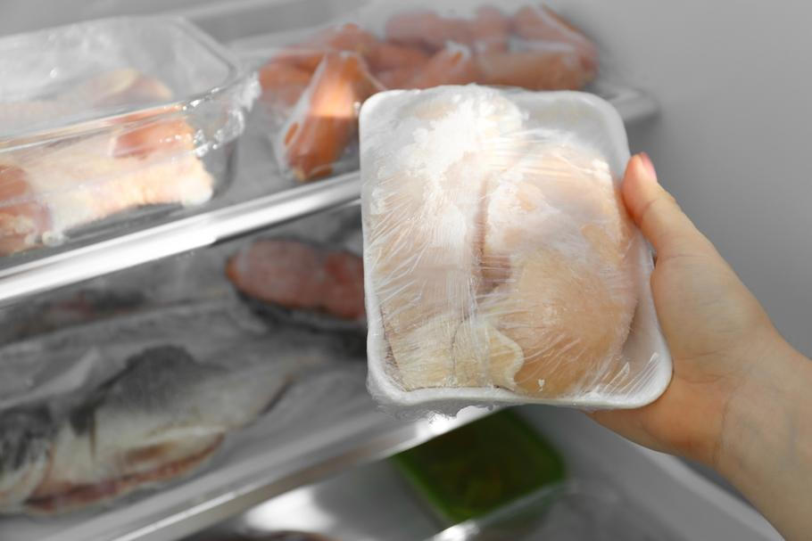 Woman,Taking,Frozen,Chicken,Breasts,Out,Of,Fridge,,Closeup