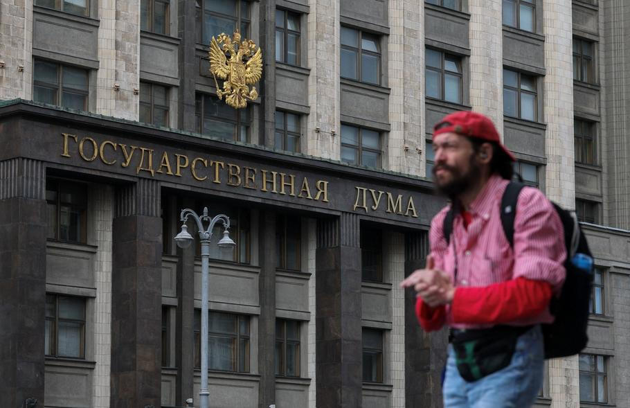 A man walks in front of the State Duma in Moscow