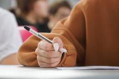 A,Girl,Writes,A,Dictation,Or,Fills,Out,Documents,In