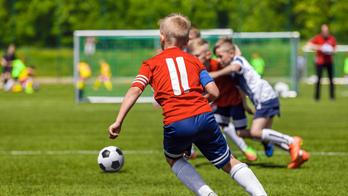 Football Soccer Match for Children. Kids Playing Soccer Game Tournament. Boys Running and Kicking Football. Youth Soccer Coach in the Background