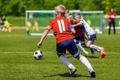 Football Soccer Match for Children. Kids Playing Soccer Game Tournament. Boys Running and Kicking Football. Youth Soccer Coach in the Background