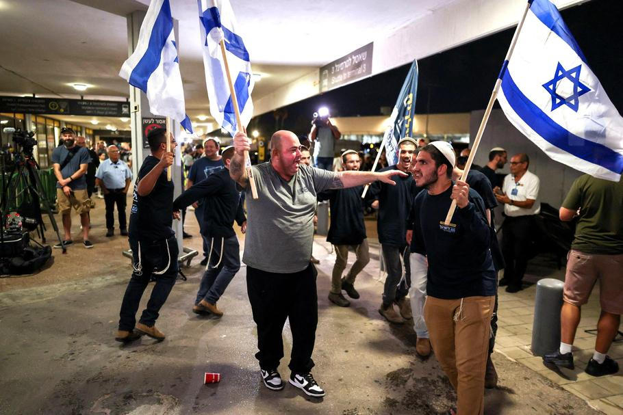 Passengers from a FlyDubai flight to Israel from United Arab Emirates that was diverted to Saudi Arabia after an emergency signal arrive at Ben Gurion International Airport 