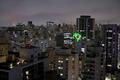 An image of Brazilian territory and the phrase “Brazil is a democracy, election without Trump” (o Brasil e uma democracia, eleicao e sem Trump) are projected on a building