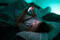 Child,Holding,Smartphone,Under,Blanket,Light.,Kid,Using,Technology,During