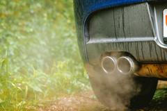 Car,Twin,Exhaust,Pipe,Tips,Emitting,Smoke,Or,Condensation.,Low
