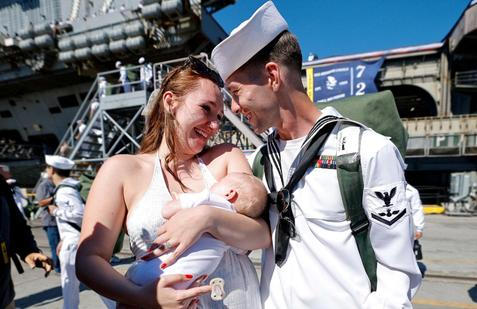 The US Navy Nimitz-class aircraft carrier USS Abraham Lincoln returns home following an extended deployment in the Middle East at Naval Base Coronado in San Diego