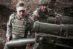 FILE PHOTO: Ukrainian service members fire a howitzer towards Russian troops in Zaporizhzhia region