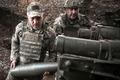 FILE PHOTO: Ukrainian service members fire a howitzer towards Russian troops in Zaporizhzhia region