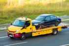 Yellow,Flatbed,Tow,Truck,Transporting,Broken,Down,Car,On,Highway